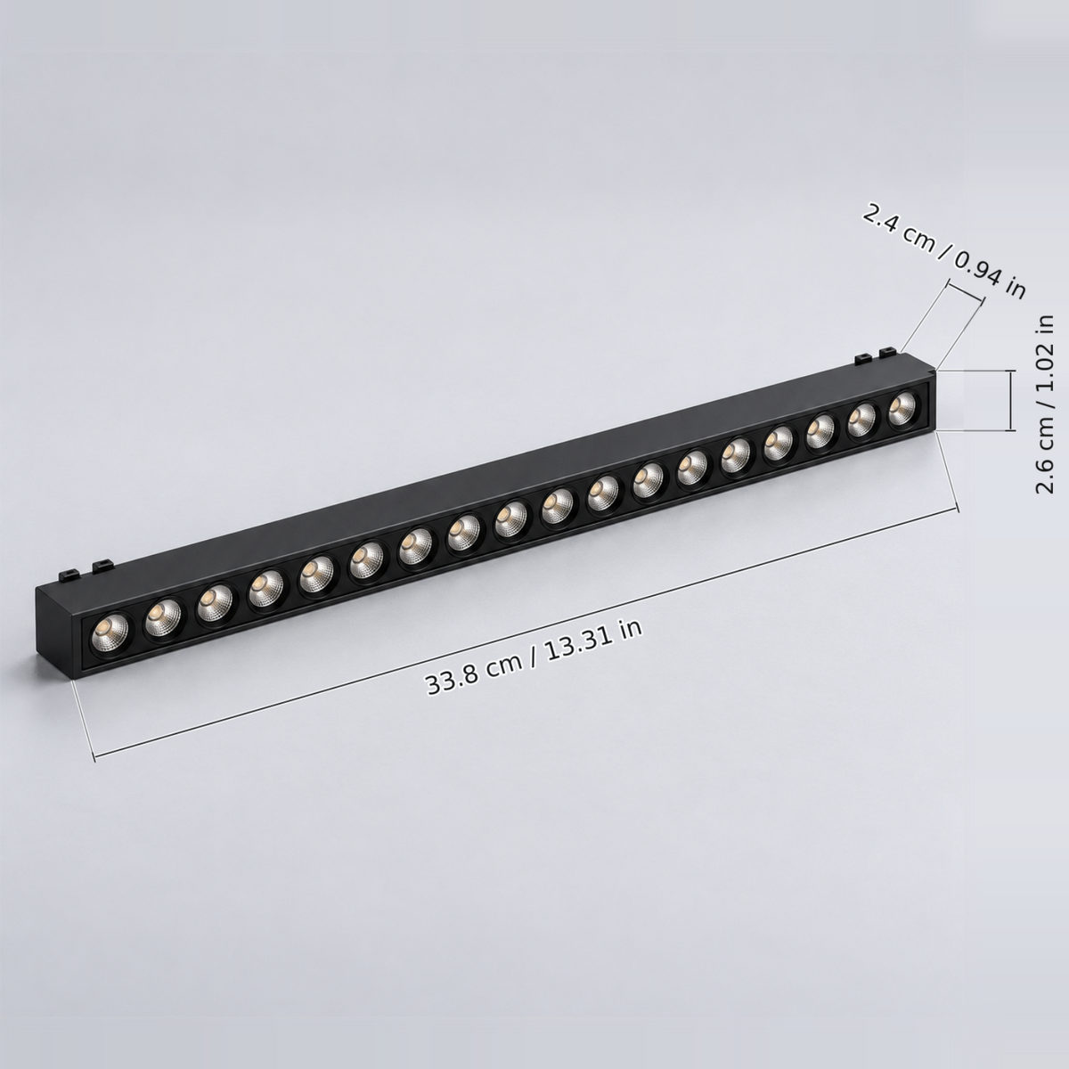 Black grille light 18w with dimension lines in centimetres and inches: Body length 33.8 cm / 13.31 in; Body width 2.6 cm / 1.02 in; Body height excluding contacts 2.4 cm / 0.94 in.