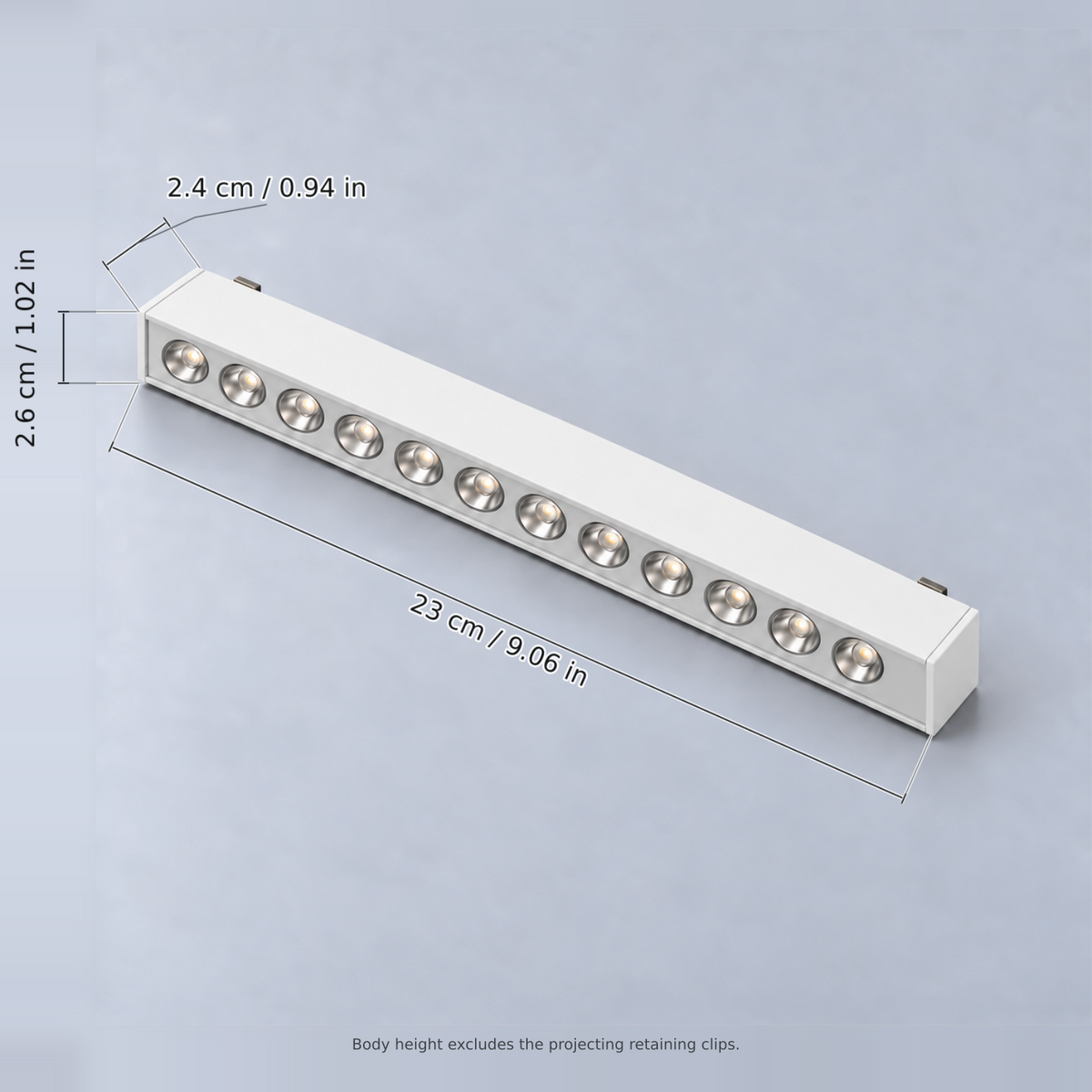 White grille light 12w with dimension lines in centimetres and inches: Length 23 cm / 9.06 in; Width 2.6 cm / 1.02 in; Body height 2.4 cm / 0.94 in.